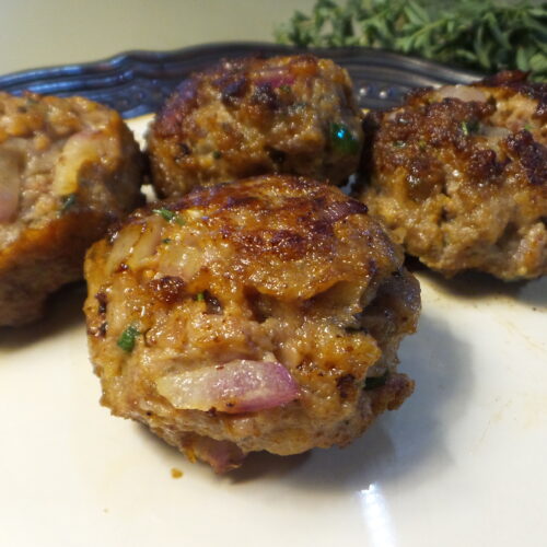 Cooked Italian meatballs sitting on a plate